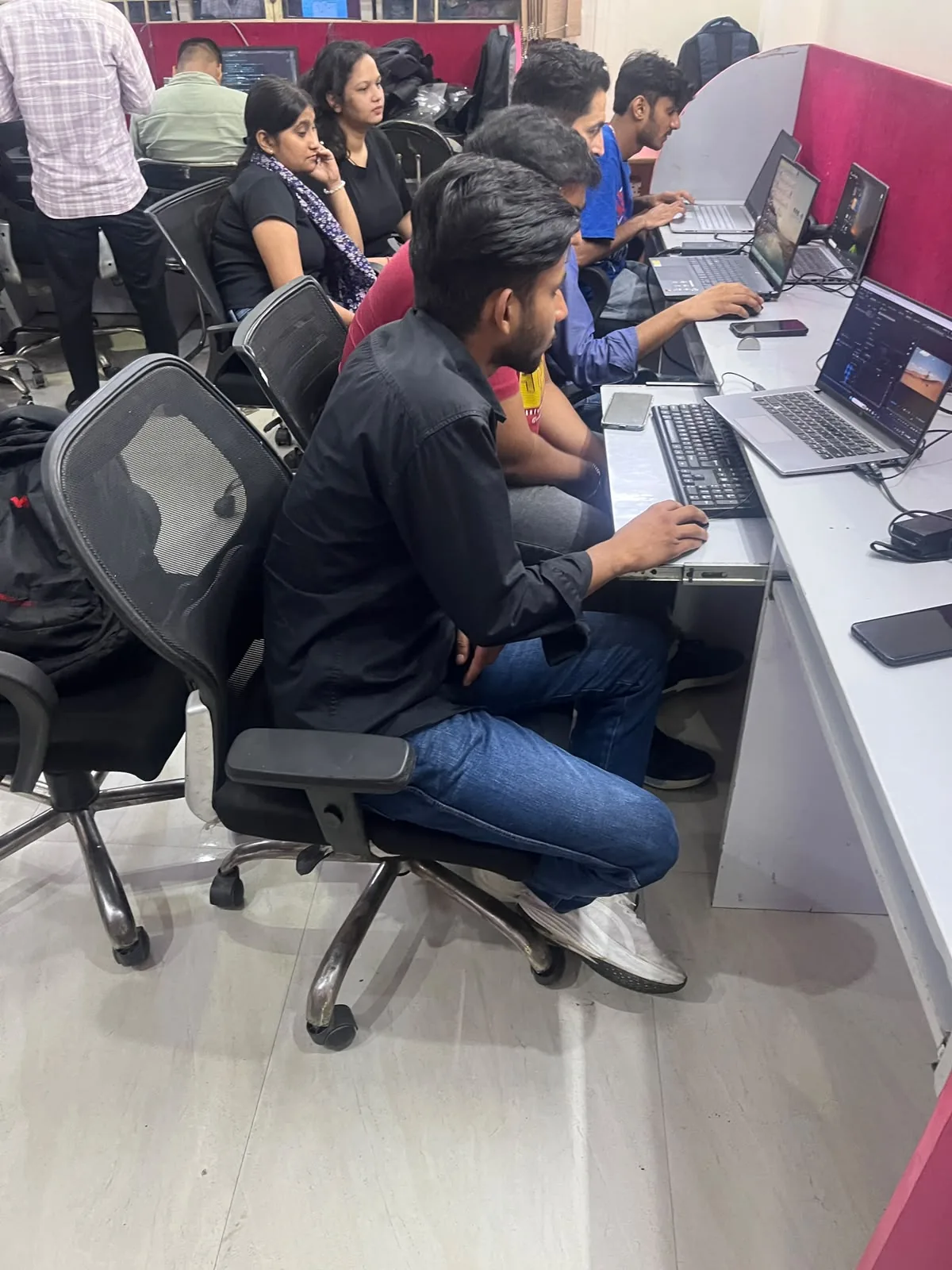 Students working at computer workstations in the lab